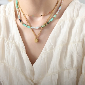 Three-layer titanium steel necklace with colorful beads and a small gold lock pendant