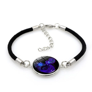 Detailed view of Aquarius constellation bracelet with black cord and glass pendant