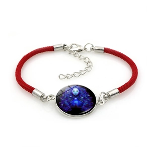 Adjustable red braided Virgo zodiac bracelet with glass cabochon on white background