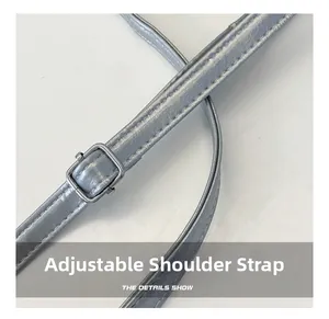 Close-up of adjustable faux leather shoulder strap with durable metal buckle for handbag
