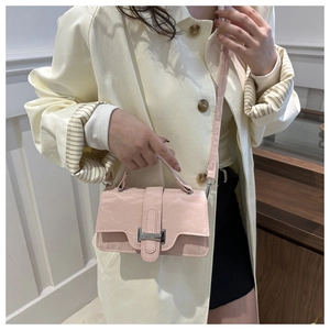 Detailed view of light pink marbled leather handbag with silver buckle and shoulder strap