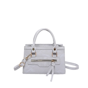 Light gray faux leather crossbody bag with decorative metal zippers and fringe tassel charms