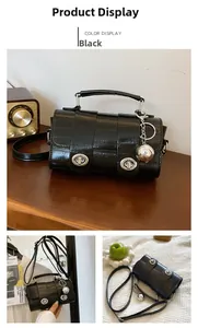 Close-up of black PU leather vintage crossbody bag with dual silver metal turn locks