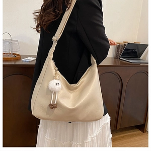 Chic beige large capacity leather tote bag with cute plush pendant for daily commute