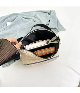 Detailed interior of the beige quilted crossbody bag showing spacious capacity and lining