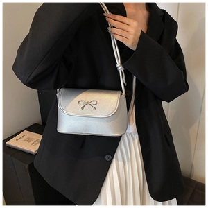 Stylish silver shoulder bag for women with cute bow detail, chic underarm bag for daily wear.