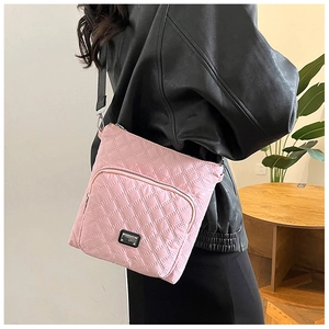Pink nylon crossbody bag featuring diamond quilted pattern and metal logo plate detail