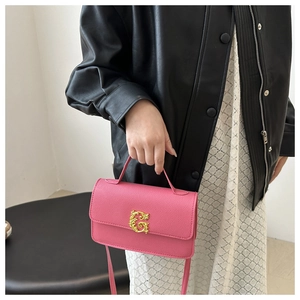 Pink lychee texture crossbody bag featuring a golden baroque G buckle in a lifestyle setting