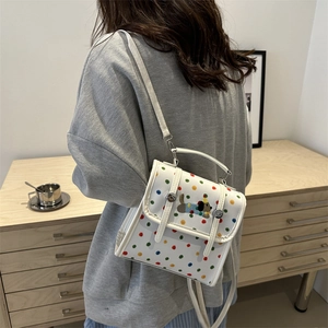 Polka dot dachshund mini backpack shown as a crossbody bag on a female model