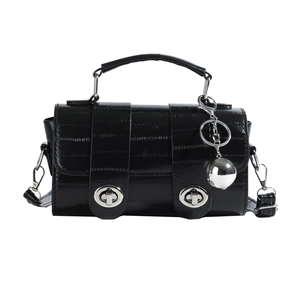 Minimalist black glossy textured handbag with silver twist locks and sphere pendant detail