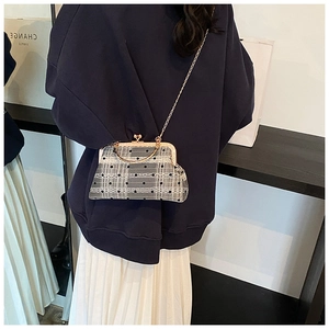 Detail of vintage rectangular bag with lace polka dots and golden bamboo top handle