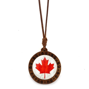 Close-up of wooden Canada maple leaf pendant necklace with intricate spiral carvings