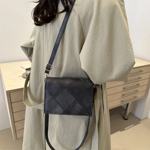 Minimalist diamond quilted crossbody bag in dark grey with adjustable gold buckle strap