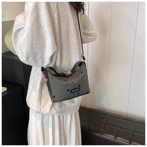 Close-up of canvas crossbody bag with star pattern and black rich rabbit logo