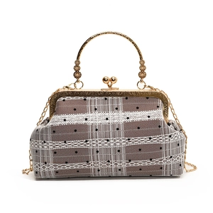 Vintage shell bag with lace polka dots, bamboo handle and gold chain strap in a classic look