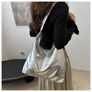 Detail of silver metallic tote bag showing soft PU leather texture and slouchy design