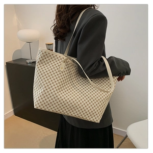 Detail of minimalist cream tote bag with brown geometric pattern and leather straps
