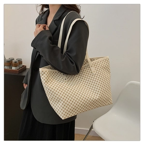 Brown geometric pattern large tote bag worn by model in a minimalist modern interior