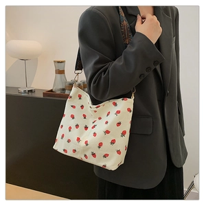 White corduroy bucket bag with strawberry pattern and bohemian style wide shoulder strap