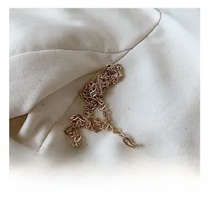 Detailed close-up of a premium gold metal chain strap with high-gloss polished finish