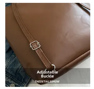 Detail of adjustable silver buckle and premium brown leather strap with neat stitching