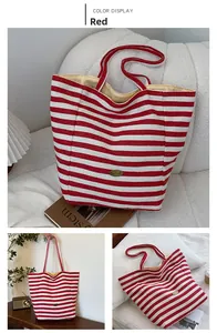 Detailed views of red striped canvas tote bag with handmade metal plaque and yellow lining