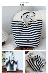 Close-up of striped canvas tote bag showing handmade logo and yellow interior lining