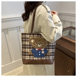 Brown plaid tote bag featuring a 3D plush bear patch and slim leather straps for women