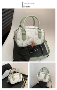 Detail view of the green butterfly print shoulder bag showing front and side capacity