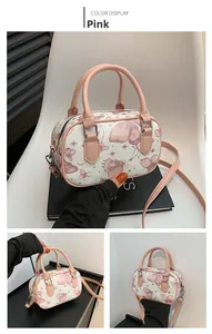 Close-up of pink butterfly print on stylish Boston bag with double leather handles