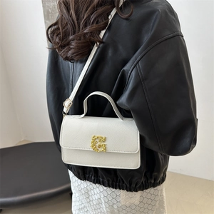 White lychee pattern leather square bag with gold G buckle on model side view