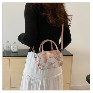 Rear view of a model wearing the white crossbody bag with pink butterfly patterns