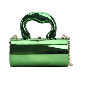Close-up of emerald green acrylic box bag with high-gloss mirror finish and wide handle