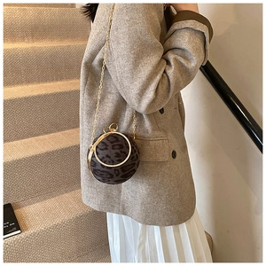 Detail of leopard print spherical handbag with rhinestone handle and gold chain