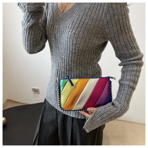 Detail of colorful rainbow metallic leather crossbody bag with chain strap and silver beads