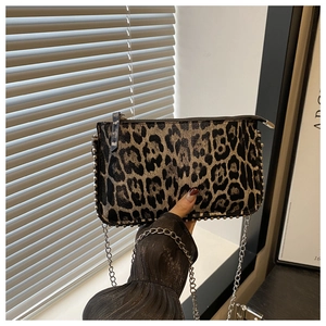 Detail of leopard print crossbody bag with silver studs and metal chain strap