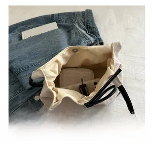 Interior view of large canvas tote bag showing storage capacity for phone and wallet