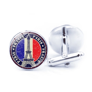 Detailed macro view of Eiffel Tower cufflinks featuring French flag colors and Paris logo
