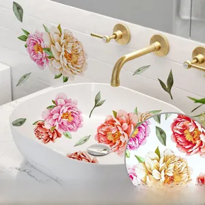 Detail of floral wall stickers on ceramic sink featuring pink and orange peonies
