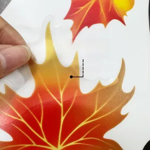 Detail showing adhesive backing of the hand-painted autumn maple leaf wall decal sticker