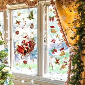 Christmas window decals with Santa on a sleigh and trees for festive glass decoration
