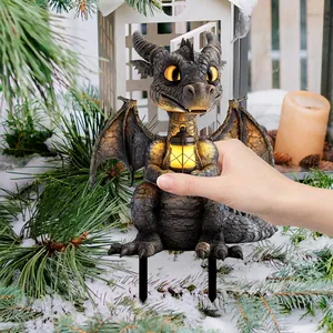 Garden dragon statue with glowing lantern and ground stakes for outdoor winter decor