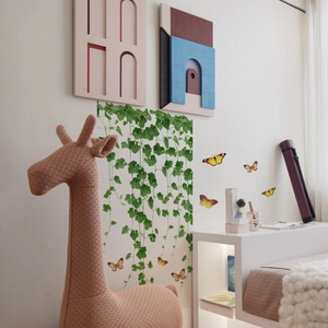 Close-up of green vine leaf wall stickers with colorful butterflies for room decoration