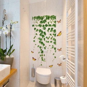 Detail of waterproof vine wall stickers with orange butterflies on a white bathroom wall