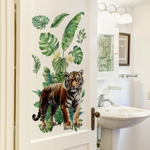 Detail of tropical tiger and lush green leaves wall stickers on a white wooden door