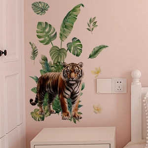 Detail of jungle wall stickers with realistic tiger and tropical green leaves on pink wall