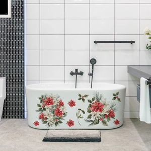 Detail of white bathtub decorated with Christmas poinsettia flowers and green pine branches