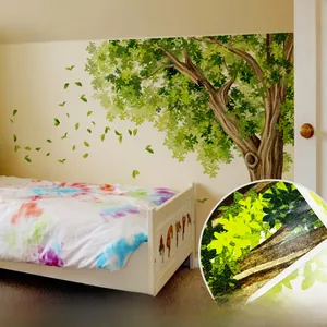 Detail of self-adhesive large tree wall decal with green leaves for nursery decoration
