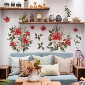 Close-up of Christmas poinsettia wall stickers with holly leaves on a living room wall