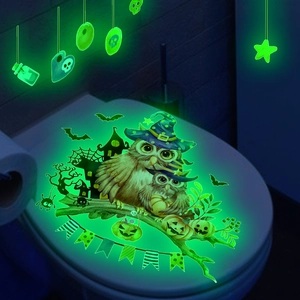 Glow-in-the-dark Halloween toilet stickers featuring cartoon owls, pumpkins, and bats